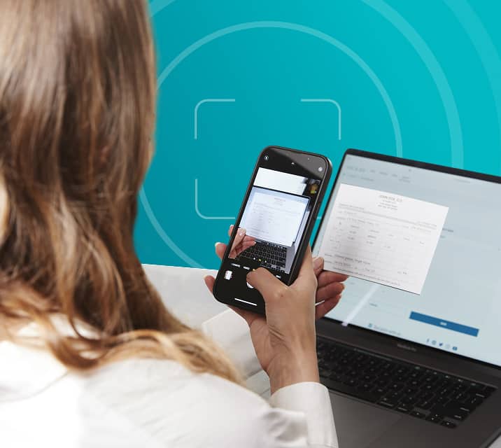 Woman scanning her written prescription with her phone.